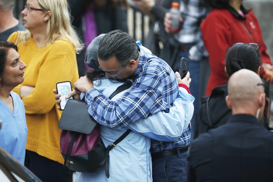 Parents hug as they wait for the arrival of their children at the recreation center where the students were reunited with their parents Tuesday, May 7, 2019, in Highlands Ranch, Colo. (AP Photo/David  ...