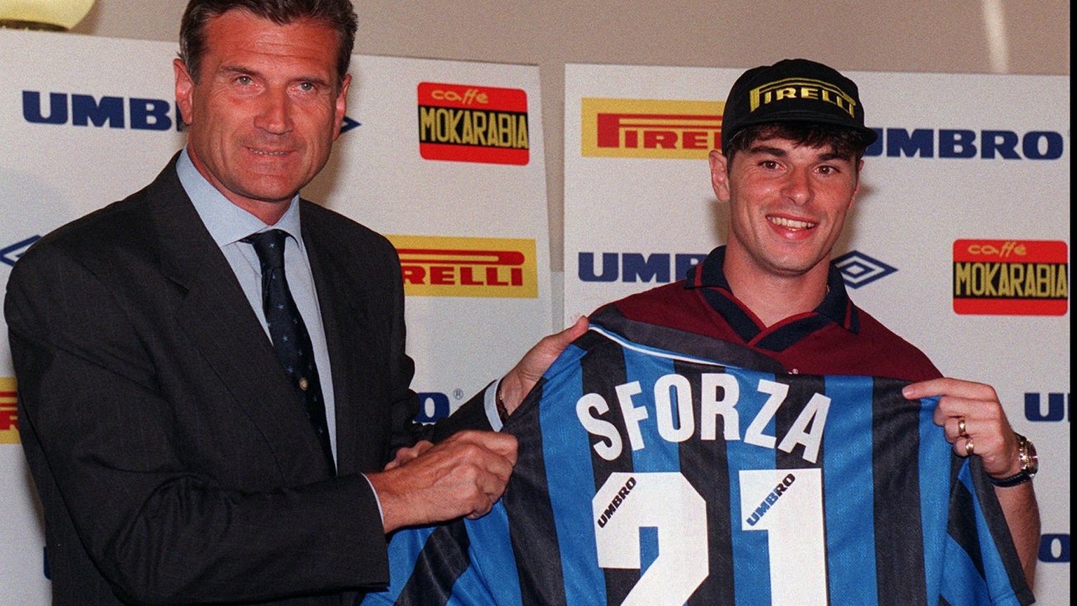 Swiss midfielder Ciriaco Sforza, right, poses with his new jersey along with Internazionale's team manager Giacinto Facchetti during the official presentation in Appiano Gentile, near Milan, Thur ...