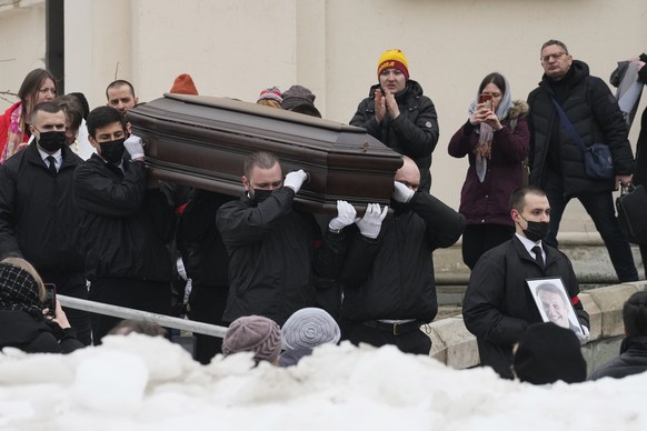 Workers carry the coffin and a portrait of Russian opposition leader Alexei Navalny out of the Church of the Icon of the Mother of God Soothe My Sorrows, in Moscow, Russia, Friday, March 1, 2024. Rela ...