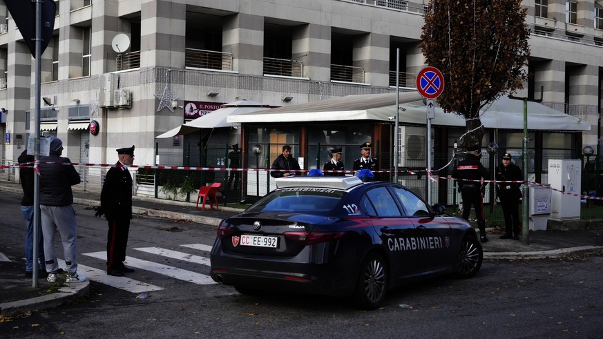 Italian Carabinieri, paramilitary policemen, patrol in front of a bar where three people died after a man entered and shot in Rome, Sunday, Dec. 11, 2022. (AP Photo/Gregorio Borgia)
