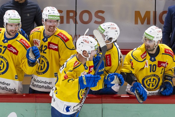 Davos&#039; forward Enzo Corvi, centre, celebrates his winner goal with teammates, during a shootout session at the National League regular season game of the Swiss Championship between Lausanne HC an ...