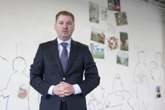 Artem Rybchenko, Ukrainian ambassador to Switzerland, poses for the photographer in front of drawings made by children, during the exhibition &quot;THROUGH THE THORNS...&quot; Art of Ukraine, this Sun ...