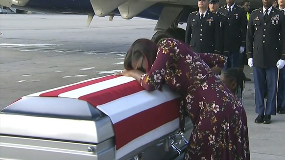 ADDS TRUMP&#039;S RESPONSE TO REP. WILSON - In this Tuesday, Oct. 17, 2017, frame from video, Myeshia Johnson cries over the casket of her husband, Sgt. La David Johnson, who was killed in an ambush i ...