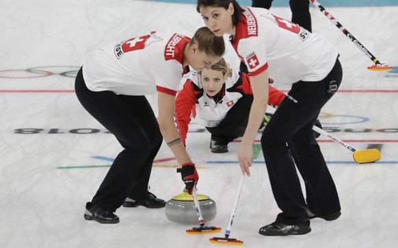 Switzerland&#039;s skip Silvana Tirinzoni,center, throws a stone during a women&#039;s curling match against Canada at the 2018 Winter Olympics in Gangneung, South Korea, Sunday, Feb. 18, 2018. (AP Ph ...