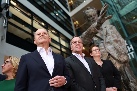 epa11739897 German Chancellor Olaf Scholz (L) looks on, next to German Defense Minister Boris Pistorius (C) and German Minister for Construction Klara Geywitz (R), during a press conference at the Soc ...