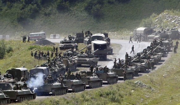 FILE - In this Saturday, Aug. 9, 2008 file photo, a column of Russian armored vehicles seen on their way to the South Ossetian capital Tskhinvali somewhere in the Georgian breakaway region, South Osse ...