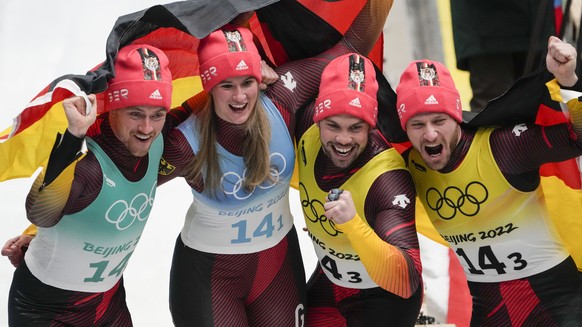 Natalie Geisenberger, Johannes Ludwig, Tobias Wendl and Tobias Arlt, of the Germany, celebrate winning the gold medal in luge team relay at the 2022 Winter Olympics, Thursday, Feb. 10, 2022, in the Ya ...