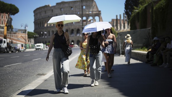 People use umbrellas in hot weather to shelter from the sun while walking past the Colosseum, in Rome, Monday, June 30, 2025. (AP Photo/Andrew Medichini)
Italy Weather Heat Wave