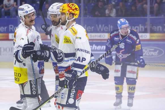 HC Ambri-Piotta Stuermer Laurent Dauphin celebrates his goal that made the score 1-5 with Isacco Dotti and PostFinance top scorer Michael Spacek during the National League ice hockey championship game between…