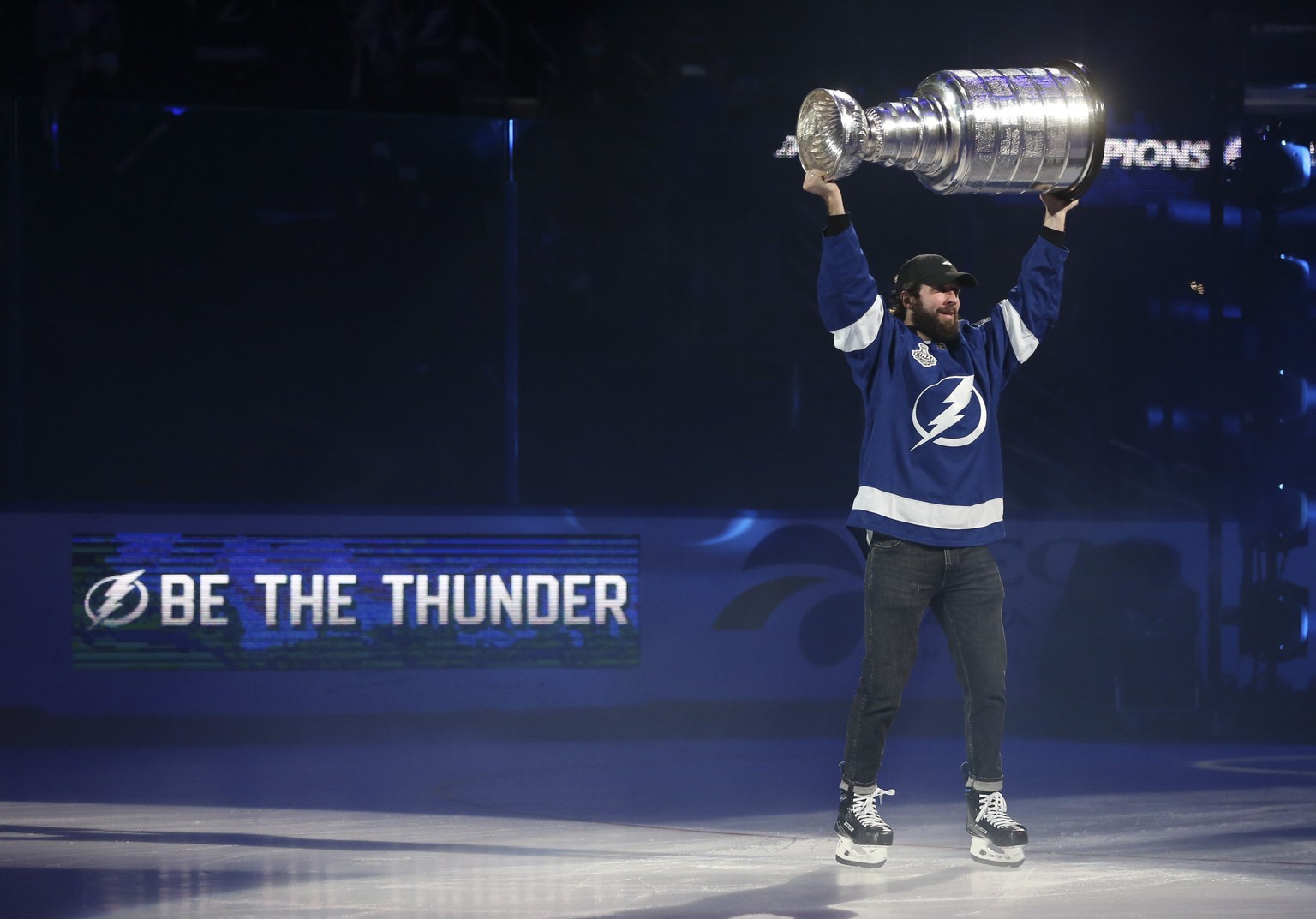 Tampa Bay Lighting's Nikita Kucherov holds the Stanley Cup in the air while skating around Amalie Arena, Tuesday, Sept. 29, 2020, in Tampa, Fla. (Dirk Shadd/Tampa Bay Times via AP)