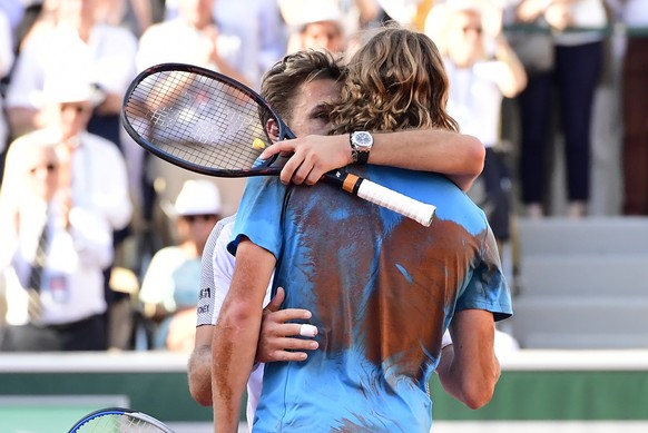 epa07620637 Stan Wawrinka of Switzerland (L) reacts after winning against Stefanos Tsitsipas of Greece (R) their men’s round of 16 match during the French Open tennis tournament at Roland Garros in Pa ...