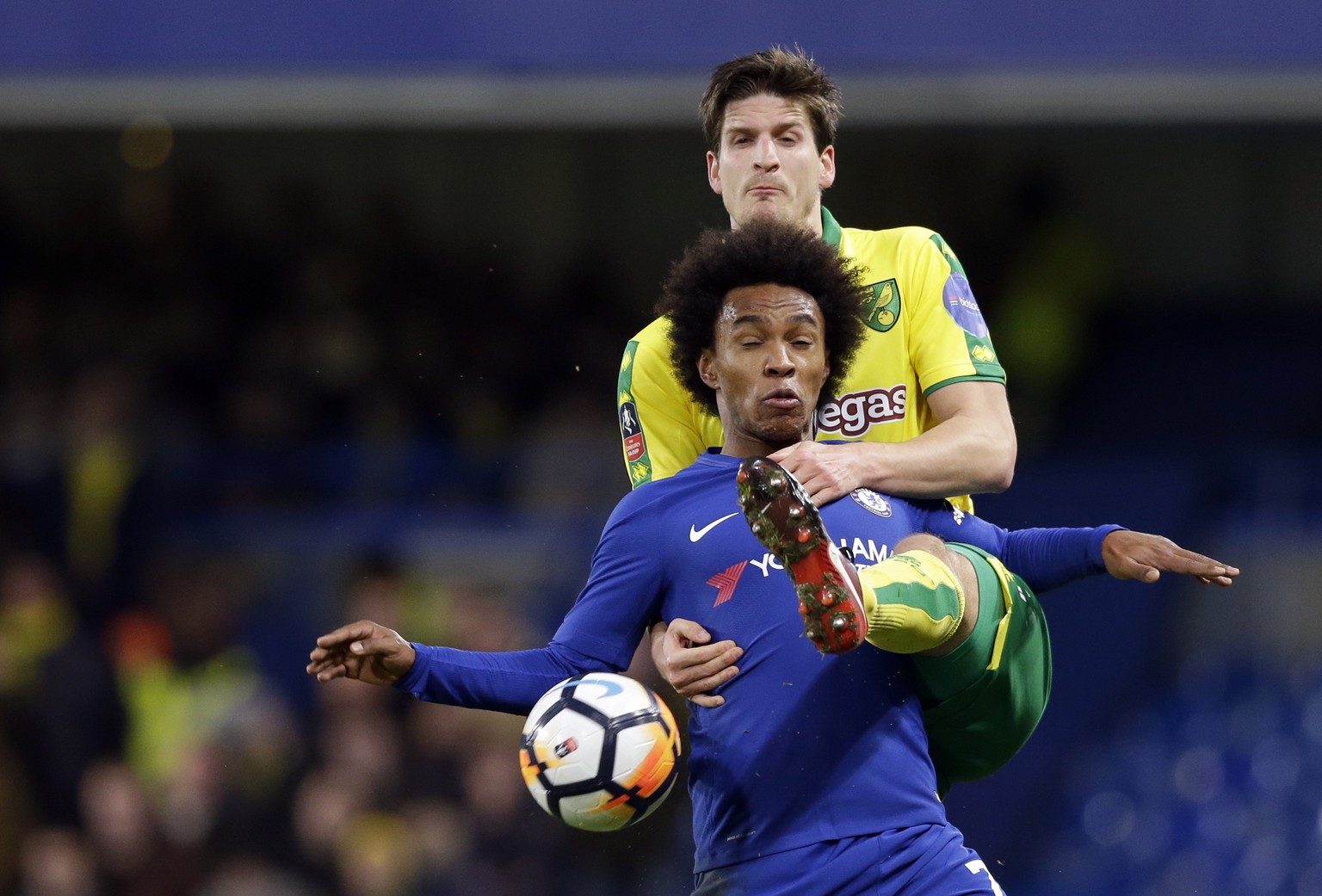 Chelsea&#039;s Willian, front, duels for the ball with Norwich City&#039;s Timm Klose during the English FA Cup third round replay between Chelsea and Norwich City at the Stamford Bridge, in London, W ...