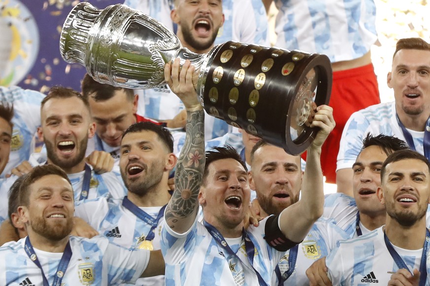 Argentina&#039;s Lionel Messi holds the trophy as he celebrates with the team after beating 1-0 Brazil in the Copa America final soccer match at the Maracana stadium in Rio de Janeiro, Brazil, Saturda ...