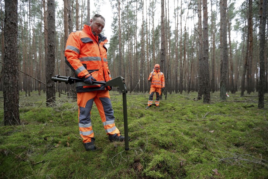In this Wednesday, Jan. 8, 2020 photo members of a bomb disposal team search for World War II munition at the site of the planned new Tesla Gigafactory in Gruenheide near Berlin, Germany. Tesla CEO El ...