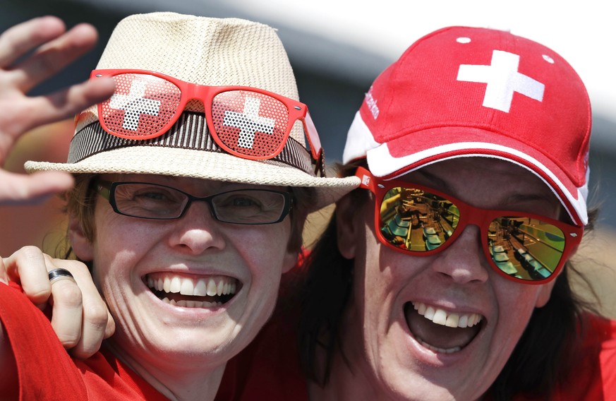 Swiss fans smile as they wait for the start of a match between Timea Bacsinszky, of Switzerland, and Zhang Shuai, of China, the 2016 Summer Olympics in Rio de Janeiro, Brazil, Saturday, Aug. 6, 2016.  ...