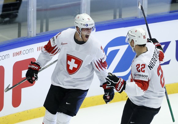 Switzerland&#039;s Enzo Corvi, left, celebrates with teammate Nino Niederreiter, right, after scoring his sides first goal during the Ice Hockey World Championships quarterfinal match between Finland  ...