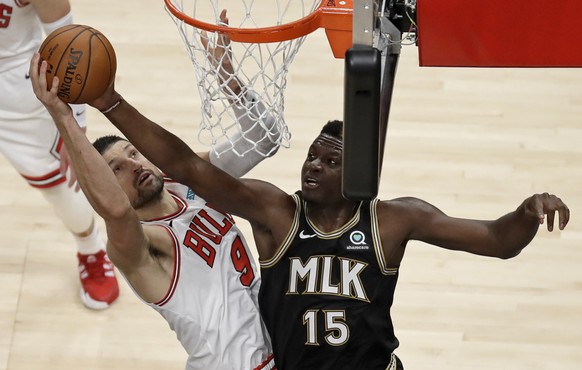 Chicago Bulls&#039; Nikola Vucevic, left, and Atlanta Hawks&#039; Clint Capela (15) vie for a rebound during the first half of an NBA basketball game Friday, April 9, 2021, in Atlanta. (AP Photo/Ben M ...