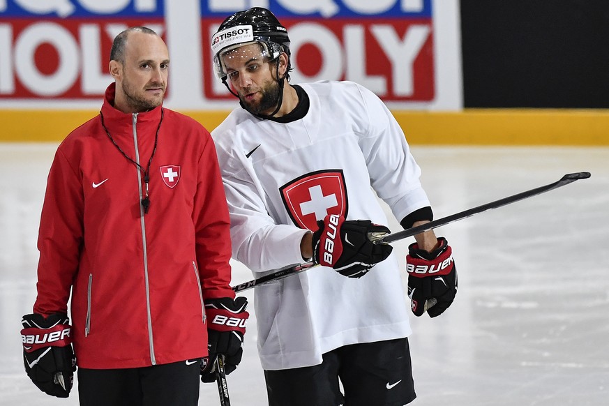 Switzerland’s assistant coach Christian Wohlwend, left, and player Thomas Ruefenacht speak during a training session during the Ice Hockey World Championship in Paris, France on Wednesday, May 17, 201 ...