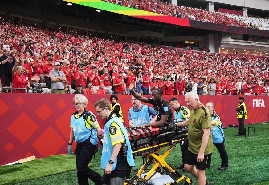Canada's Ismael Kone waves to the crowd as he is stretchered off the field after an injury during the World Cup Group B soccer match between Canada and Qatar in Vancouver, British Columbia, Thurs ...