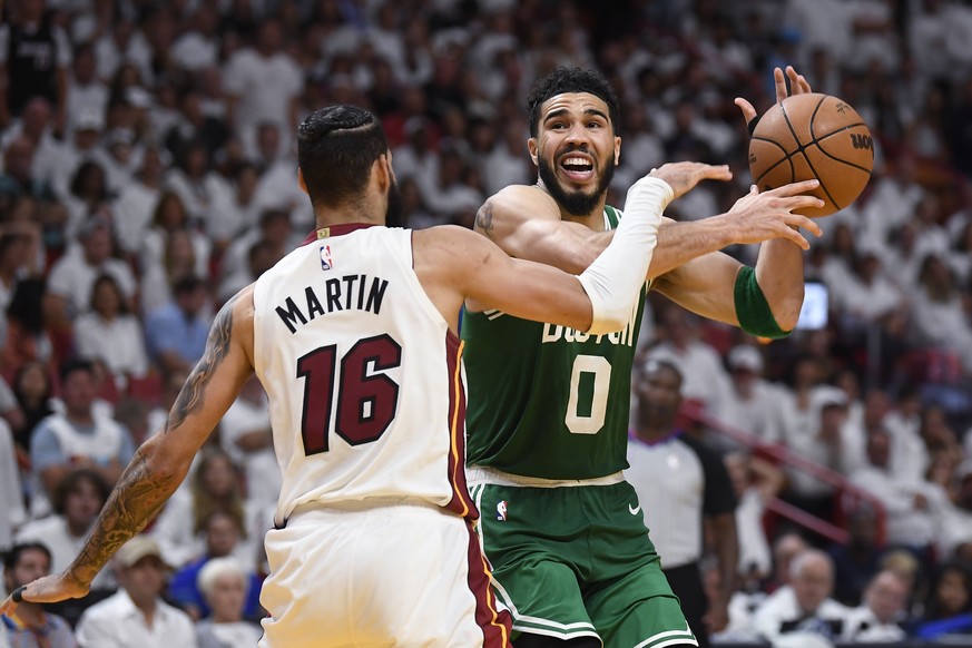 Miami Heat forward Caleb Martin (16) bats the ball away from Boston Celtics forward Jayson Tatum (0) during the second half of Game 6 of the NBA basketball Eastern Conference finals, Saturday, May 27, ...