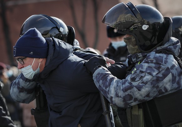 epa09805285 Russian policemen detain a participant in an unauthorized rally against the Russian special operation in Ukraine, in downtown Moscow, Russia, 06 March 2022. According to independent Russia ...