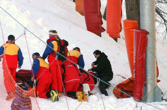 Rescuers give firs aid to ski racer Silvano Beltrametti of Switzerland, after he crashed during the first men's World Cup downhill of the season in Val d'Isere, France, on Saturday Dec. 8, 2 ...