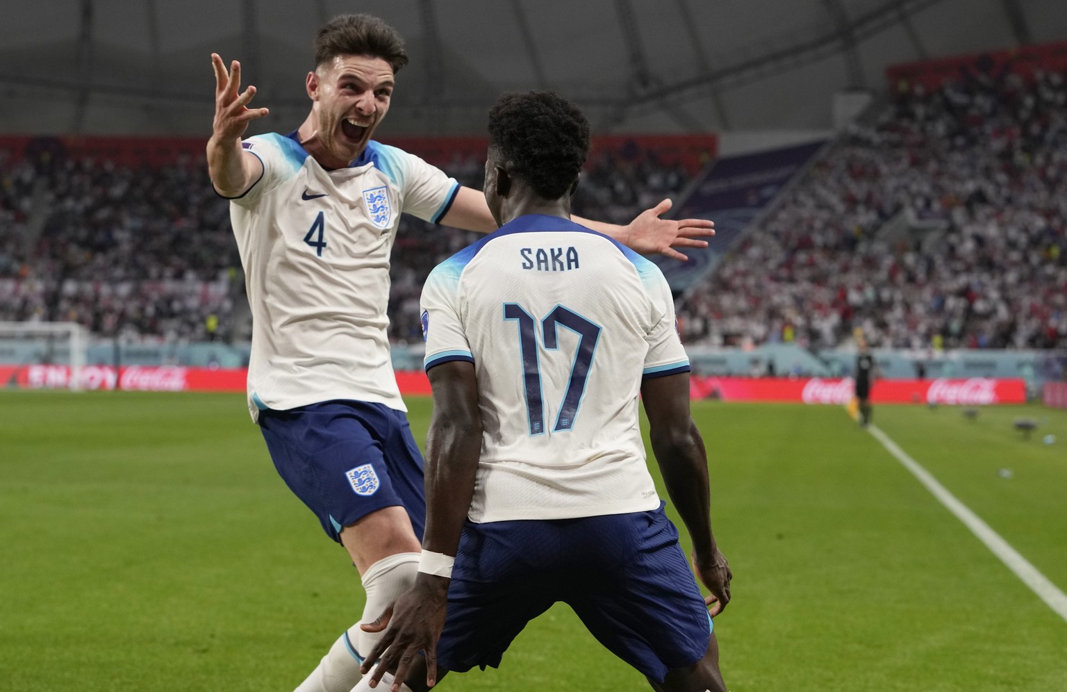 England&#039;s Bukayo Saka celebrates with England&#039;s Declan Rice after scoring his side&#039;s second goal during the World Cup group B soccer match between England and Iran at the Khalifa Intern ...