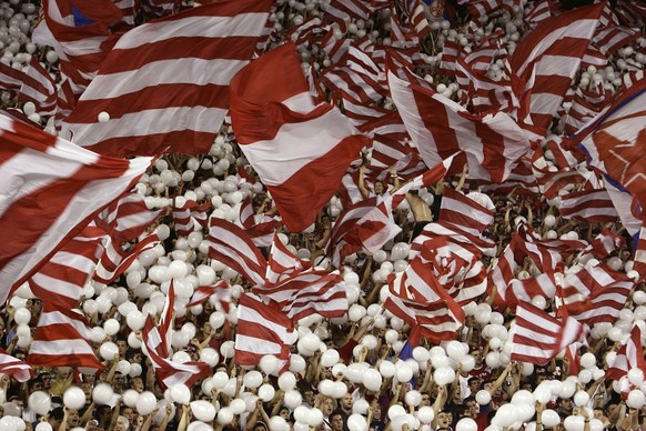 Red Star Belgrade fans wave red and white balloons and flags before the UEFA Champions League third qualifying round soccer match between Red Star and Glasgow Rangers, Belgrade, Serbia, Tuesday, Aug.  ...