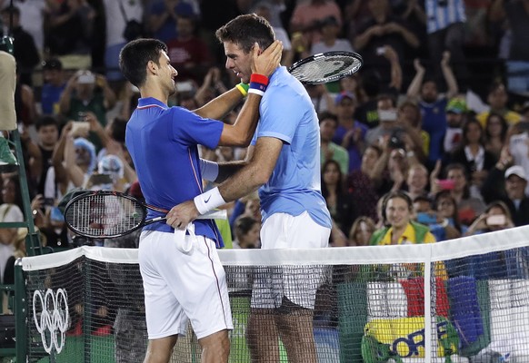 Juan Martin del Potro, of Argentina, right, is embraced by Novak Djokovic, of Serbia, after del Potro won in two tie break sets at the 2016 Summer Olympics in Rio de Janeiro, Brazil, Sunday, Aug. 7, 2 ...