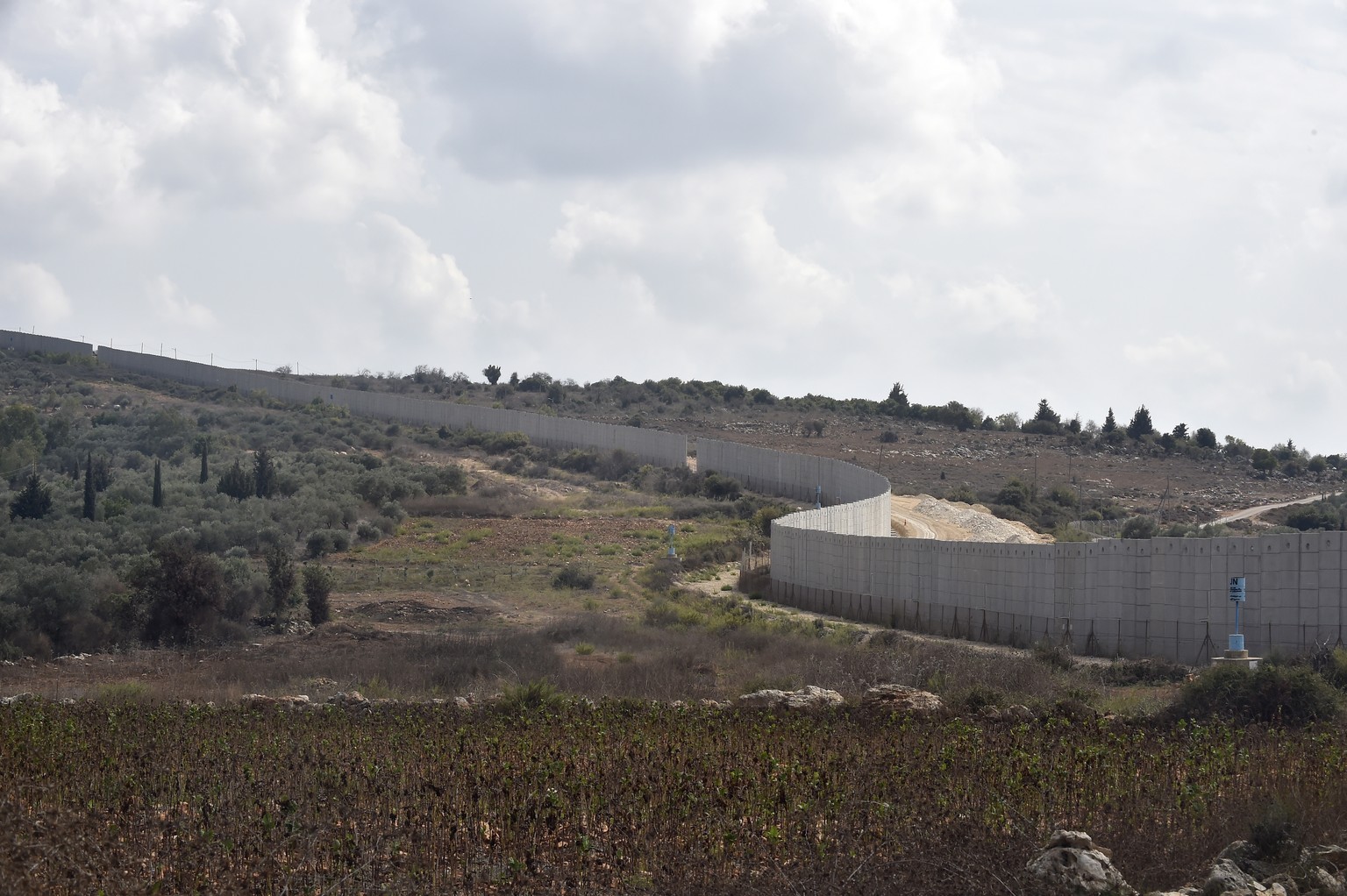 epa10911864 A general view of the wall at the Israeli-Lebanon border, seen from the Dhayra village, southern Lebanon, 10 October 2023. According to Hezbollah, three fighters of the group were killed d ...