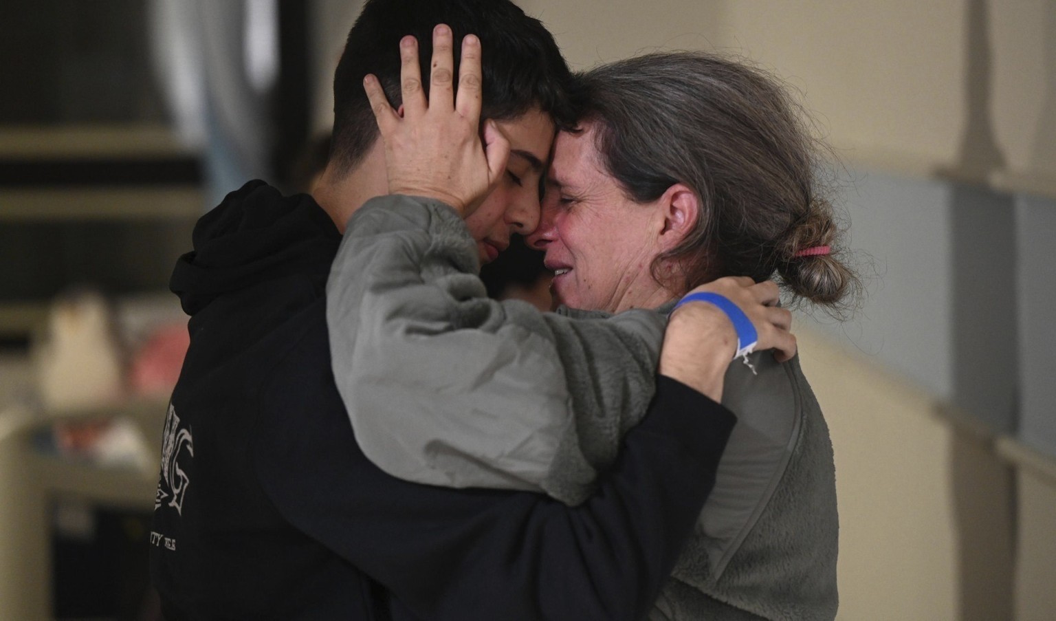 This handout photo provided by Haim Zach/GPO shows Sharon Hertzman, right, hugging a relative as they reunite at Sheba Medical Center in Ramat Gan, Israel, Saturday Nov. 25, 2023. Sharon Hertzman and  ...