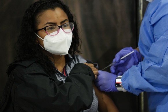 Kiara Morales, 31, gets a shot of the AstraZeneca vaccine for COVID-19 at the Mega Mall on the outskirts of Panama City, Wednesday, June 9, 2021. On Wednesday, Panama began vaccinating women age 30 and older. (AP Photo/Arnulfo Franco)