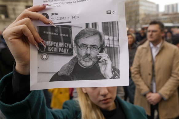 A woman holds a leaflet with the image of journalist Slavko Curuvija during a protest in front of the Serbian Court of Appeal, in Belgrade, Serbia, Monday, February 5, 2024. Media rights groups and opposition…