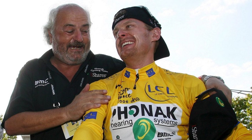 Phonak team manager Andy Rihs (L) congratulates US Floyd Landis (Phonak Hearing Systems team) in the yellow jersey of the overall leader following the lap of honour after the twentieth stage of the 93 ...