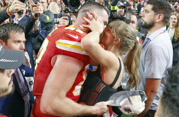 epa13082569 (FILE) - Kansas City Chiefs tight end Travis Kelce (L) kisses US singer Taylor Swift following the Chiefs' victory in overtime of Super Bowl LVIII between the Kansas City Chiefs and t ...