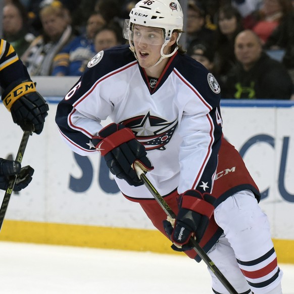 Buffalo Sabres center Sam Reinhart (23) pursues as Columbus Blue Jackets defenseman Dean Kukan (46), of the Czech Republic, looks to pass the puck up ice during the first period of an NHL hockey game, ...