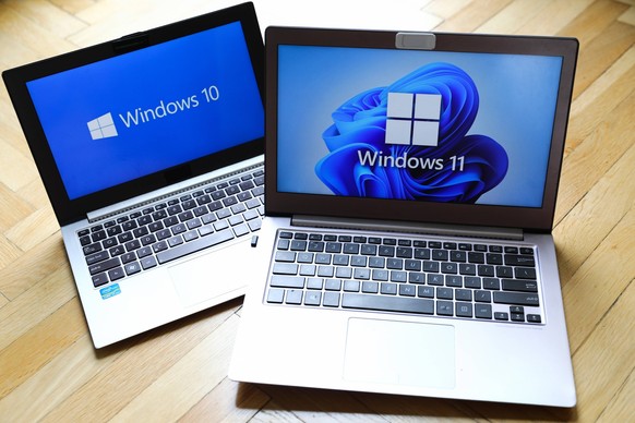 Windows 11 Vs. Windows 10 Windows 11 and Windows 10 operating system logos are displayed on laptop screens for illustration photo. Krakow, Poland on February 3, 2022. Krakow Poland PUBLICATIONxNOTxINx ...