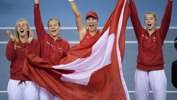 Switzerland&#039;s players Jil Teichmann, Viktorija Golubic, Belinda Bencic and Simona Waltert, from left, celebrates after defeating Australia to win the Billie Jean King Cup tennis finals, at the Em ...