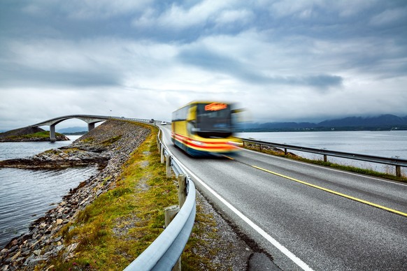 Public bus traveling on the road in Norway. Public bus in motion blur. Atlantic Ocean Road or the Atlantic Road (Atlanterhavsveien) been awarded the title as Norwegian Construction of the Century.;