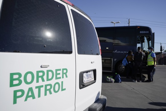 A U.S. Customs and Border Protection van is seen next to a bus picking up travelers, mostly migrants from Haiti released from CBP custody, at a gas station that serves as a bus terminal, Thursday, Sep ...