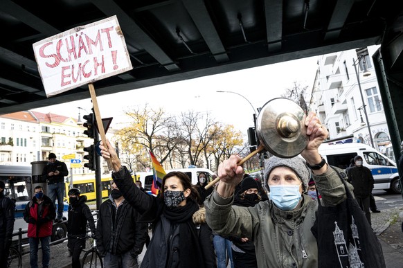 Counter demonstrators shows a poster reading: &#039;shame on you&#039; as the protest against a so called &#039;silent march&#039; against the corona policy of the federal government, at the district  ...