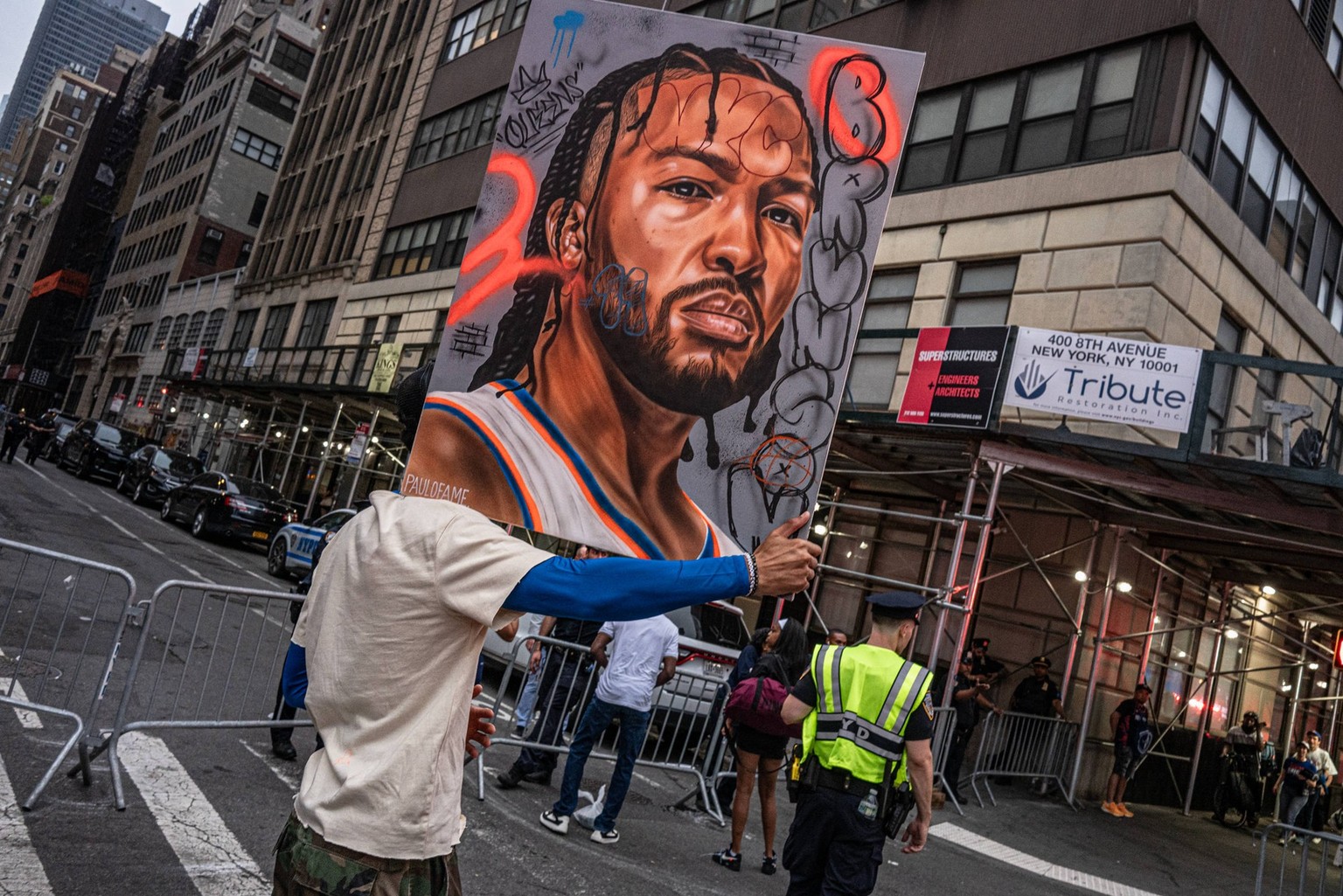 June 10, 2026, New York, New York, USA: Artist Paul Johnson holds up his painting of Knick player Jalen Brunson as fans gather in and around Madison Square Garden for Game 4 of the NBA Finals between  ...