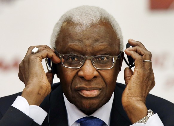 FILE - In this Aug. 21, 2015, file photo, then-IAAF president Lamine Diack adjusts his headphones during a joint IOC and IAAF news conference on the site of the World Athletic Championships in Beijing ...