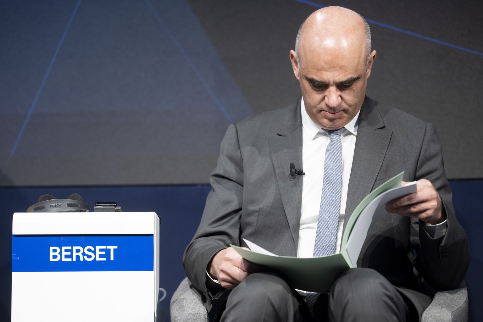 epa10415257 Switzerland&#039;s President Alain Berset, reads his documents prior to a session during the 53rd annual meeting of the World Economic Forum, WEF, in Davos, Switzerland, 19 January 2023. T ...