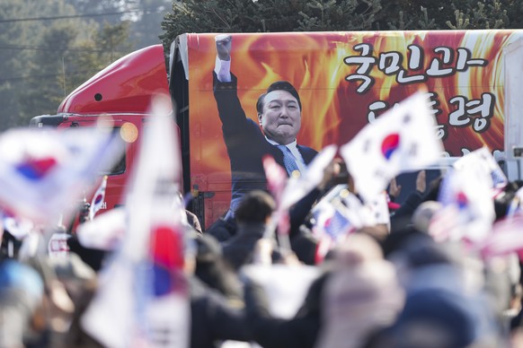 A picture of impeached South Korean President Yoon Suk Yeol is seen on the vehicle during a rally to oppose his impeachment outside of a detention center in Uiwang, South Korea, Friday, Jan. 17, 2025. ...
