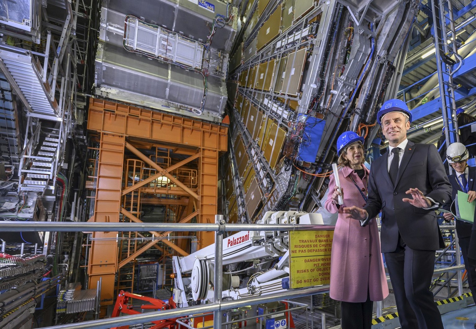 Fabiola Gianotti, left, Director General of the European Organization for Nuclear Research (CERN), and French President Emmanuel Macron, front, visit the ATLAS experiment, at the CERN (the European pa ...