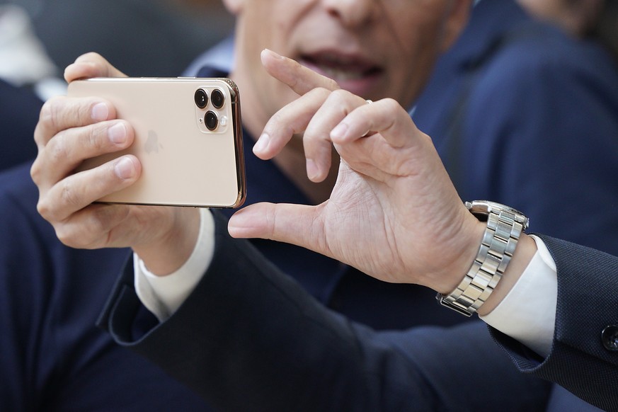 Apple team members demo the new cameras on iPhone 11 Pro for guests during an event to announce new products Tuesday, Sept. 10, 2019, in Cupertino, Calif. (AP Photo/Tony Avelar)