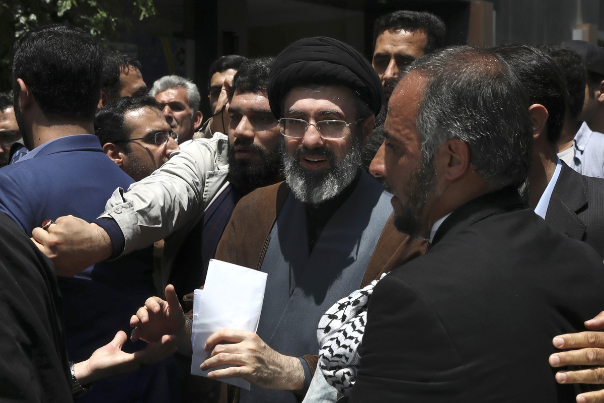 FILE - Mojtaba, son of Iranian Supreme Leader Ayatollah Ali Khamenei, center, attends the annual Quds, or Jerusalem Day rally in Tehran, Iran, on May 31, 2019. Ebrahim Raisi was seen as a prime candid ...