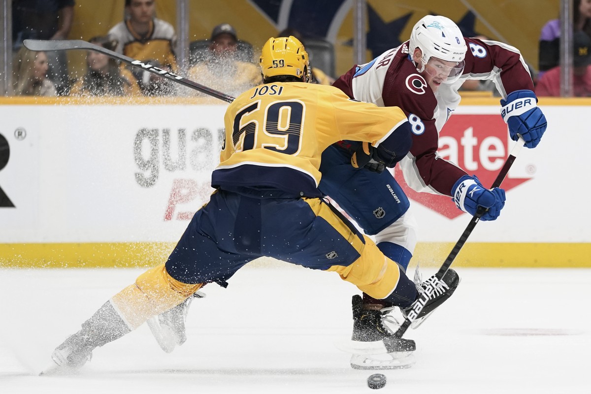 Colorado Avalanche defenseman Cale Makar (8) passes the puck past Nashville Predators' Roman Josi (59) during the first period in Game 4 of an NHL hockey first-round playoff series Monday, May 9, ...