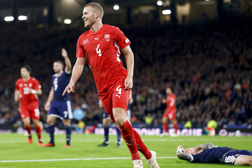 epa13271590 Switzerland's Nico Elvedi, center 4, celebrates the 0 - 2 goal during the UEFA Nations League soccer match between Scotland and Switzerland at the Hampden Park in Glasgow, Scotland, B ...